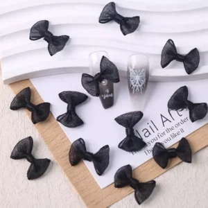 Black tulle bow nail charms scattered with two decorated tips