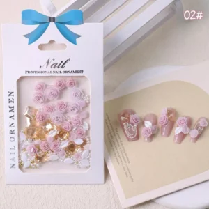 Pink nail embellishments with roses, gold gems and white leaves