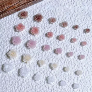 Blooming rose nail decorations with ombré pastel finish on textured base