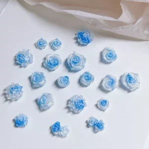 Blue resin rose nail charms in various 3D flower styles