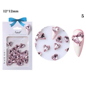 Pink crystal heart on almond-shaped nail
