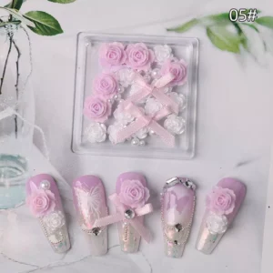 Soft rose-pink floral mix with deep red ribbon nail accents