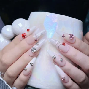Stacked rhinestones in bold color combinations on long almond nails