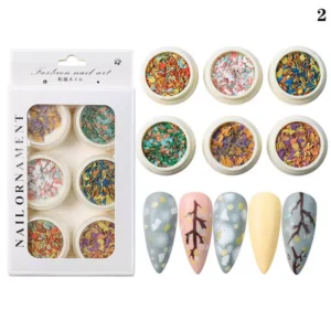 Bold crushed stone nail flakes with primary tones and floral-inspired nail art