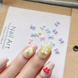 Nail display featuring pastel resin bows applied on nude base nail tips