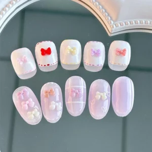 Colorful bow nail charms applied on press-on nails – cute nail art design samples