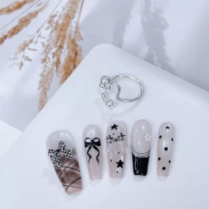 Nail sample display with various plaid bow nail embellishments in black and white