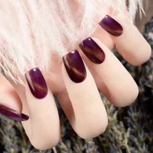 Burgundy purple cat eye gel manicure on artificial hand