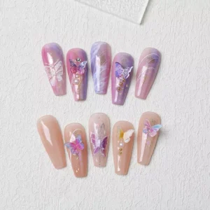 Iridescent butterfly nail art on nude and pastel acrylic nails with 3D resin charms