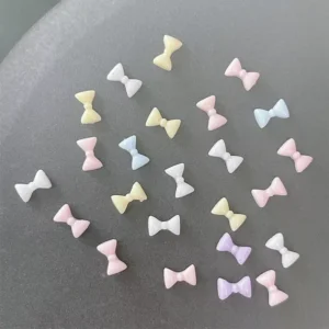 Flat resin bows in candy colors placed randomly for display under lighting