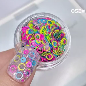 Bright neon pink, green, and yellow circular sequins in jelly-style nail glitter