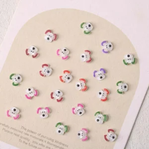 Small white puppy face nail charms with multicolor ears – cute dog nail decor