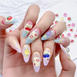 Hand showcasing nail art with cartoon fruit nail accessories