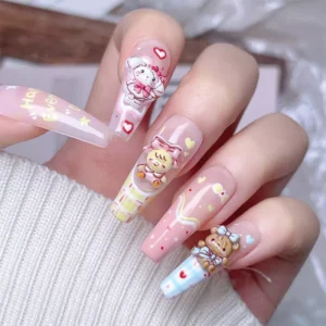 Hand with long pastel nails featuring 3D Cartoon Mikko Nail Charms in cute designs