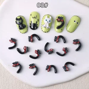 Curved black cartoon tail nail charms with red bow detailing
