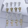 Celestial Sparkle Nail Charms - Dazzling Moon & Star Shapes 5 Celestial sparkle nail charms with moon and star shapes on mirror background