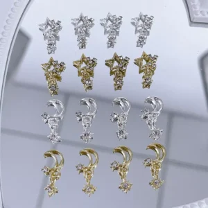 Celestial sparkle nail charms with moon and star shapes on mirror background