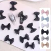 Charming mesh bow nail charms in black with nail art application