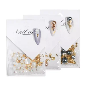 Front view of three pearl and gold nail charm packets with demo nails