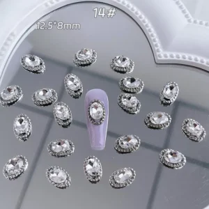 Oval-cut clear crystal nail embellishment with decorative alloy border