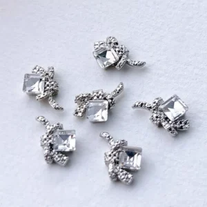 Clear rhinestone square nail charms with silver bow detailing