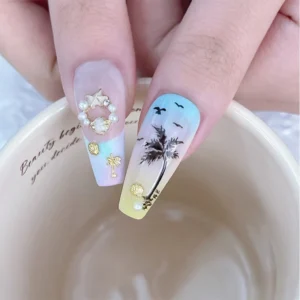 Macro view of palm tree nail art with Coastal Style Nail Embellishments including star and shell