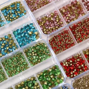 Crystal sparkling diamond nail charms in various sizes , including turquoise, red, and green stones in separate compartments.