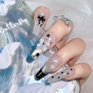 Top view of full manicure set with retro plaid bow nail accents and glitter base