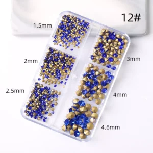 Nail art with rhinestones in various colors and shapes on nude nails.