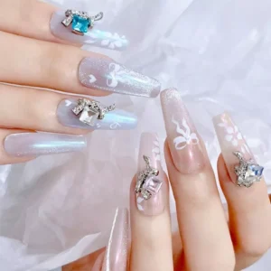 Long almond nails decorated with bow and crystal square nail charms