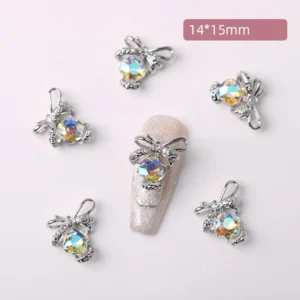 Holographic iridescent crystal bow nail charms glowing with rainbow hues
