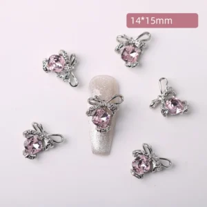 Soft pink crystal bow nail charms with silver metal detailing