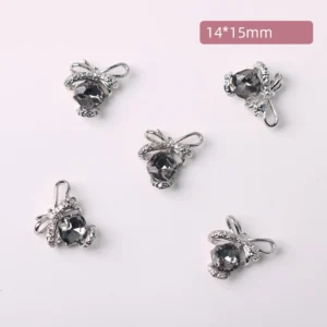Smoky grey crystal bow nail decorations displayed on white background