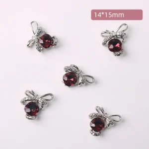 Deep wine red rhinestone nail charms with vintage bow detailing