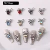 Crystal bow nail charms with crystal stones in multiple colors, flat lay view