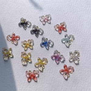Crystal-like 3D butterfly nail decorations with rhinestone centers in assorted pastel shades