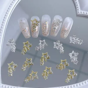 Close-up of star nail charms with dangling crystals in silver and gold finishes