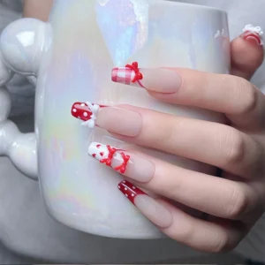 Girly manicure holding pearl mug with cute bow tie decorations