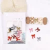 Cute matte bow nail charms with pearl accents in assorted colors on display