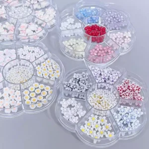 Multicolor resin 3D nail charms in rotating storage cases, featuring flowers and pearls