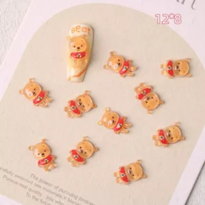 Resin teddy bear nail charms in orange with red shirts, size 12×8mm, displayed on beige card