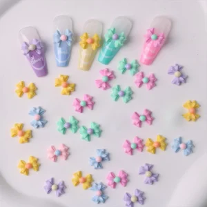 Multicolor bow nail embellishments shown with tips for style reference