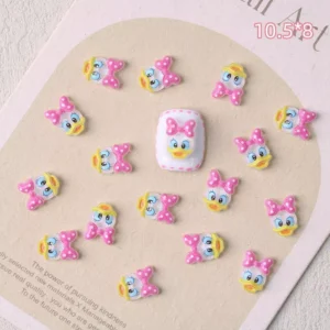 Close-up of Daisy Duck nail charms with pink polka dot bows