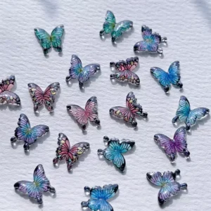Resin butterfly nail decorations with black bases and metallic edge outlines