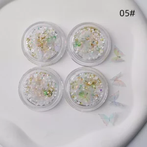 Soft pink fantasy butterfly nail charms on hand