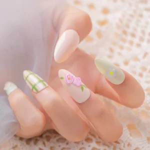 Soft-toned nail art with floral kawaii 3D resin charms applied