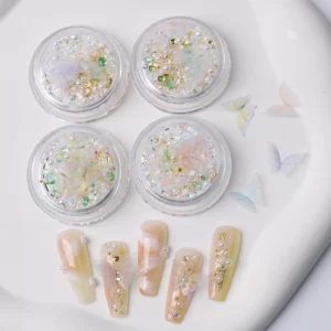 Soft beige nail art using delicate wing nail embellishments with glitter