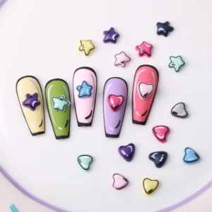 Assorted heart and star 3D nail charms styled on pastel nail tips
