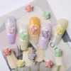 Dreamy 3D Rose Nail Charms in pastel shades with iridescent shimmer, shown on manicured nails
