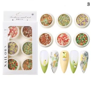 Natural warm-tone crushed nail flakes paired with soft green and ivory nails